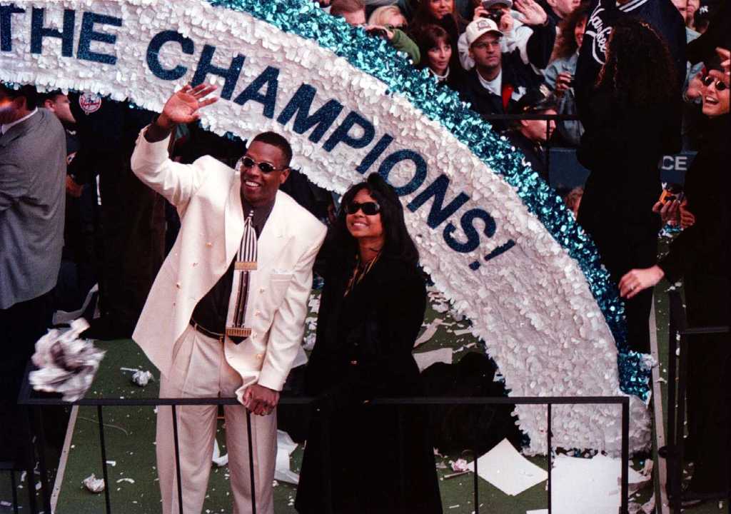 gooden in a white suit waving from a parade float