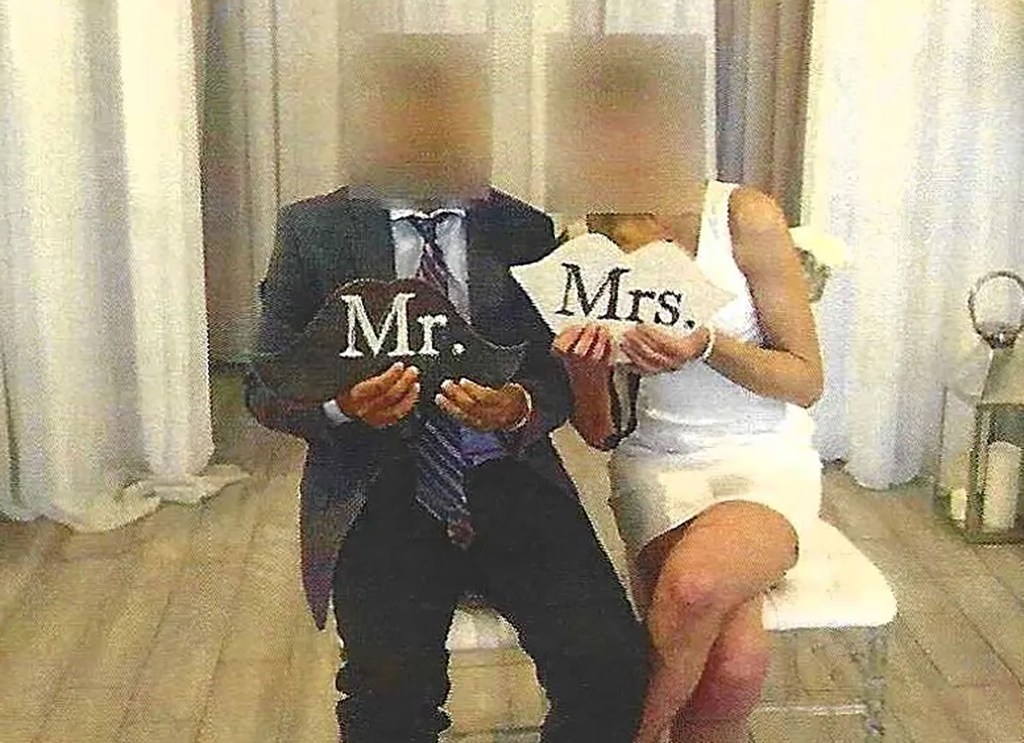 Migrants holding Mr. and Mrs. signs