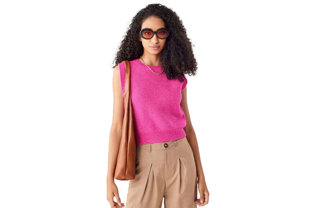 a woman wearing sunglasses and a pink shirt