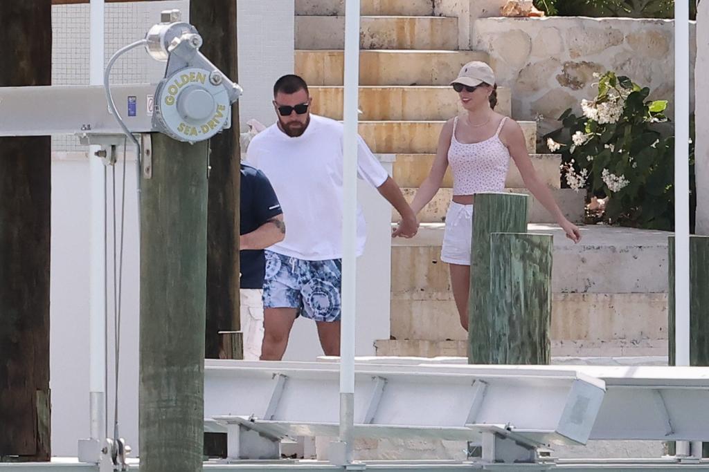 Travis Kelce appeared to lead Taylor Swift down stairs to the dock in the Bahamas.