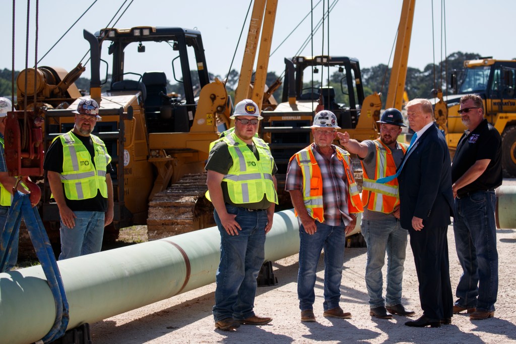 Donald Trump with engineers, outside on a construction site