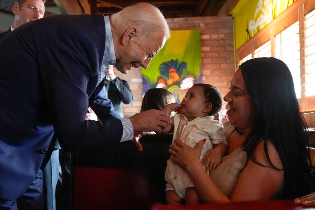 President Joe Biden greets people at a campaign event at El Portal restaurant in Phoenix.