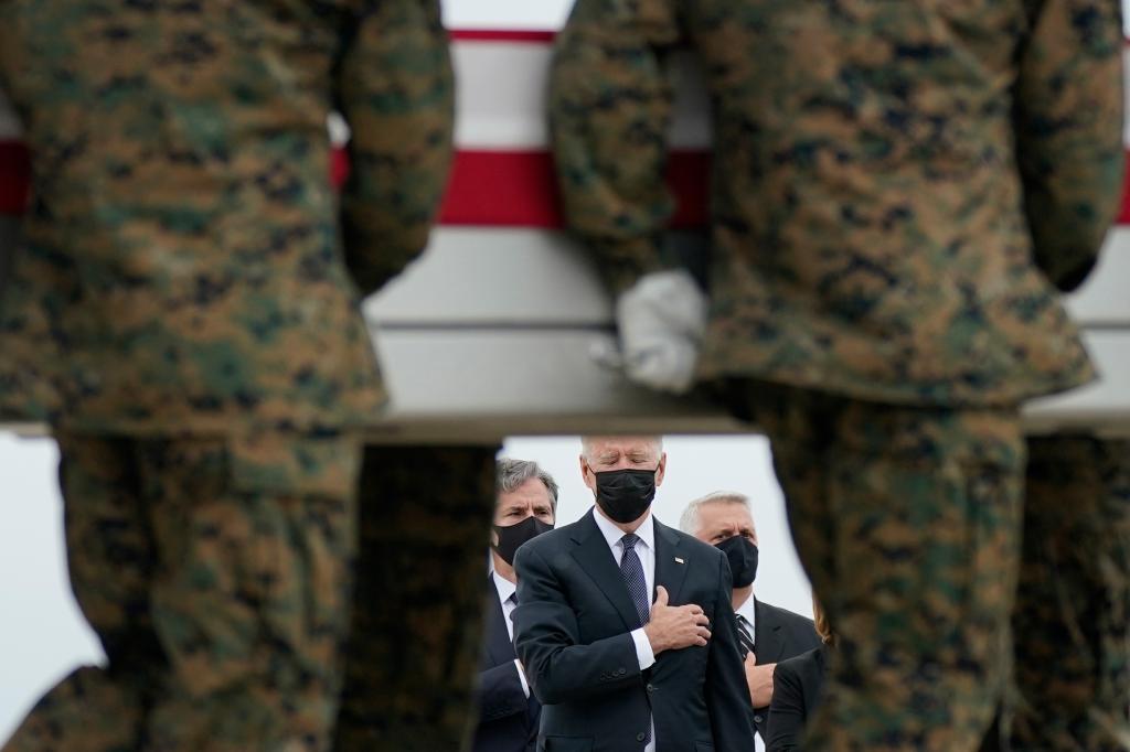 President Joe Biden watches as a carry team moves a transfer case containing the remains of Marine Corps Lance Cpl. Kareem M. Nikoui, 20, of Norco, Calif., during a casualty return Sunday, Aug. 29, 2021, at Dover Air Force Base, Del.