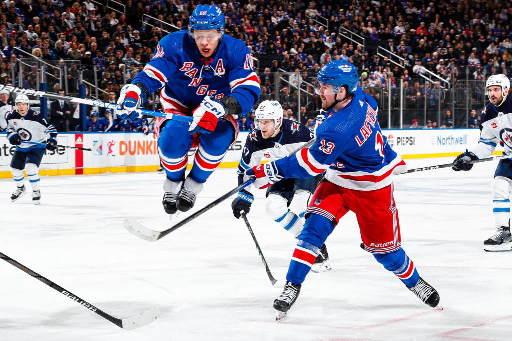 Artemi Panarin #10 of the New York Rangers leaps over the shot from Alexis Lafreniere #13 against the Winnipeg Jets at Madison Square Garden on March 19, 2024 in New York City. 