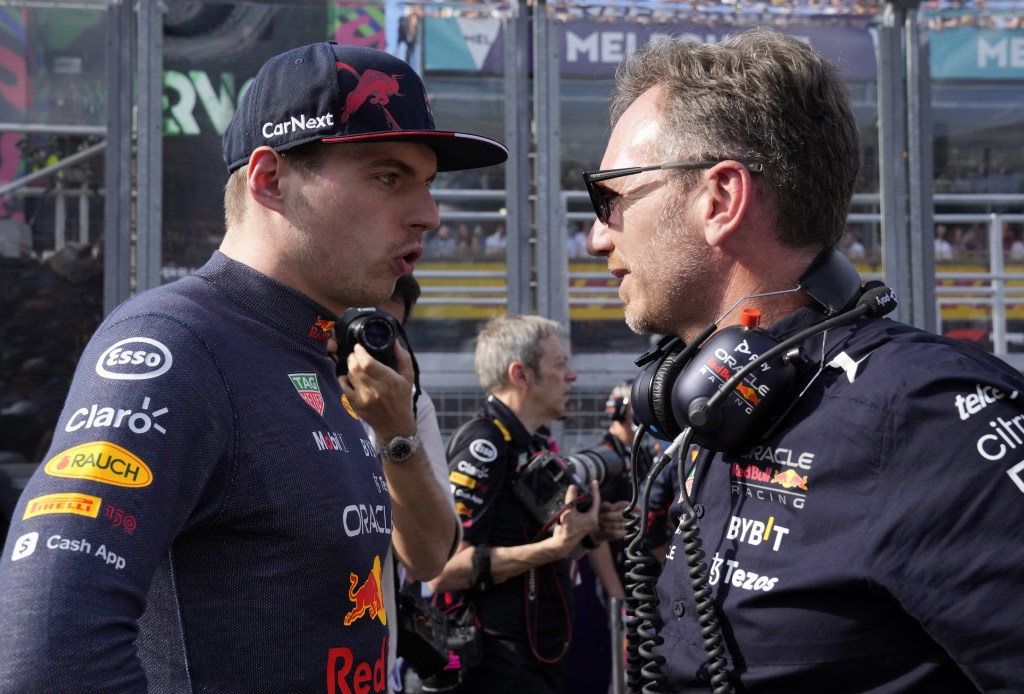 Max Verstappen and Christian Horner facing each other and talking