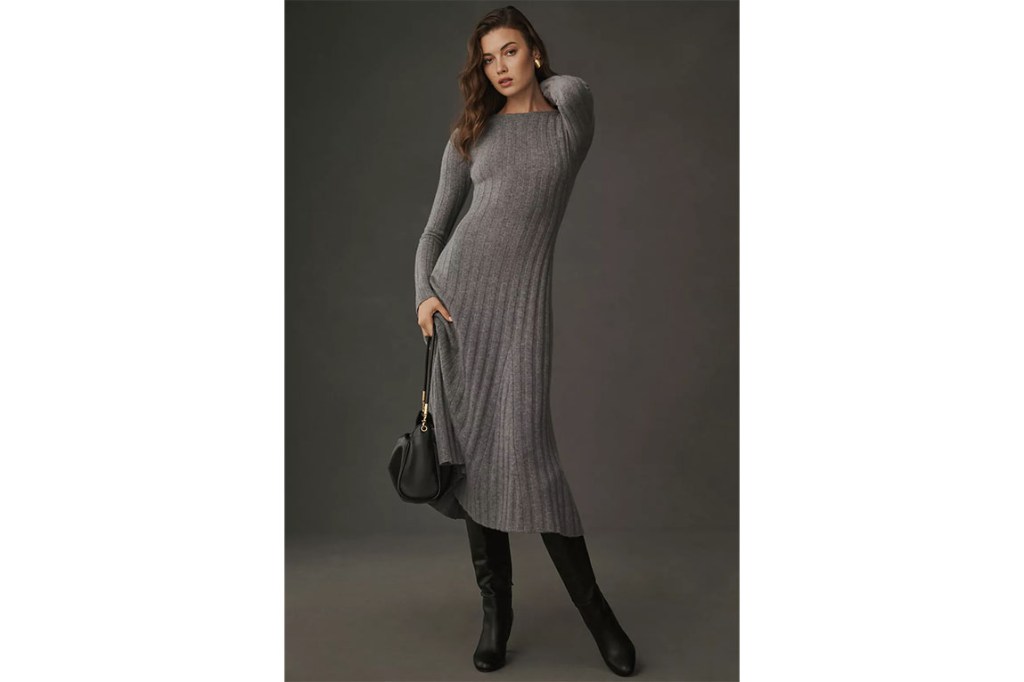 A woman wearing a long gray sweater dress.