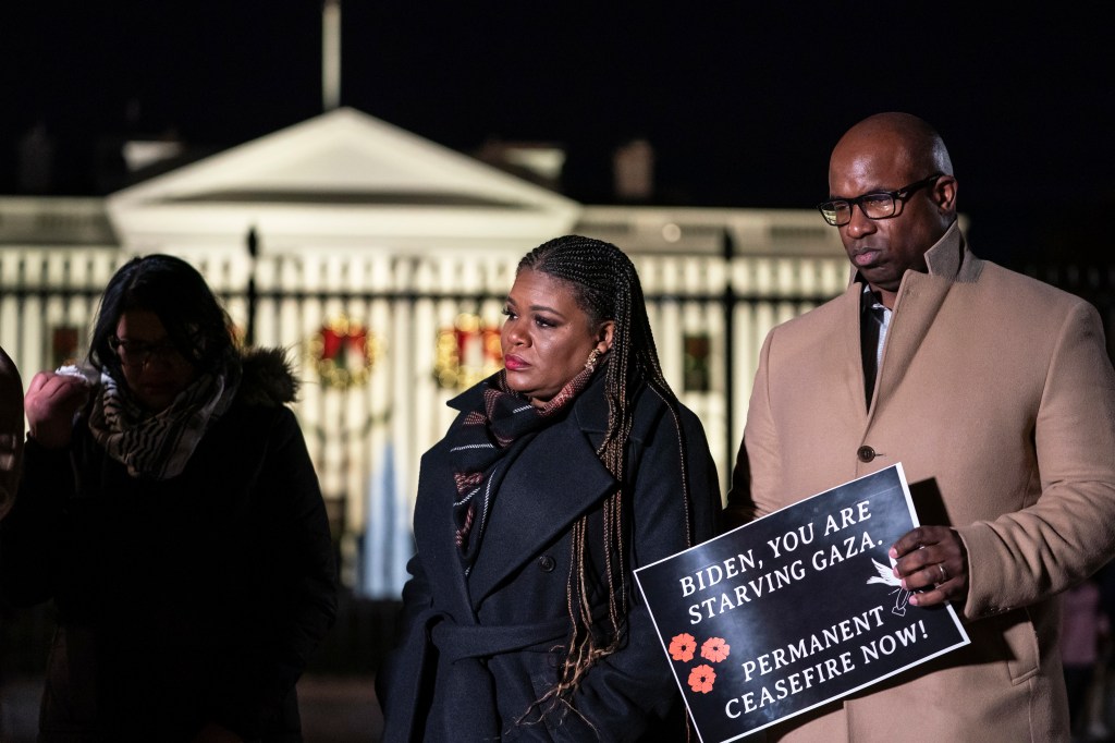 Rep. Cori Bush, D-Mo., middle, and Rep. Jamaal Bowman, D-N.Y., right, attend a vigil alongside state legislators and faith leaders currently on hunger strike outside the White House to demand that President Joe Biden call for a permanent ceasefire in Gaza on Wednesday, Nov. 29, 2023.