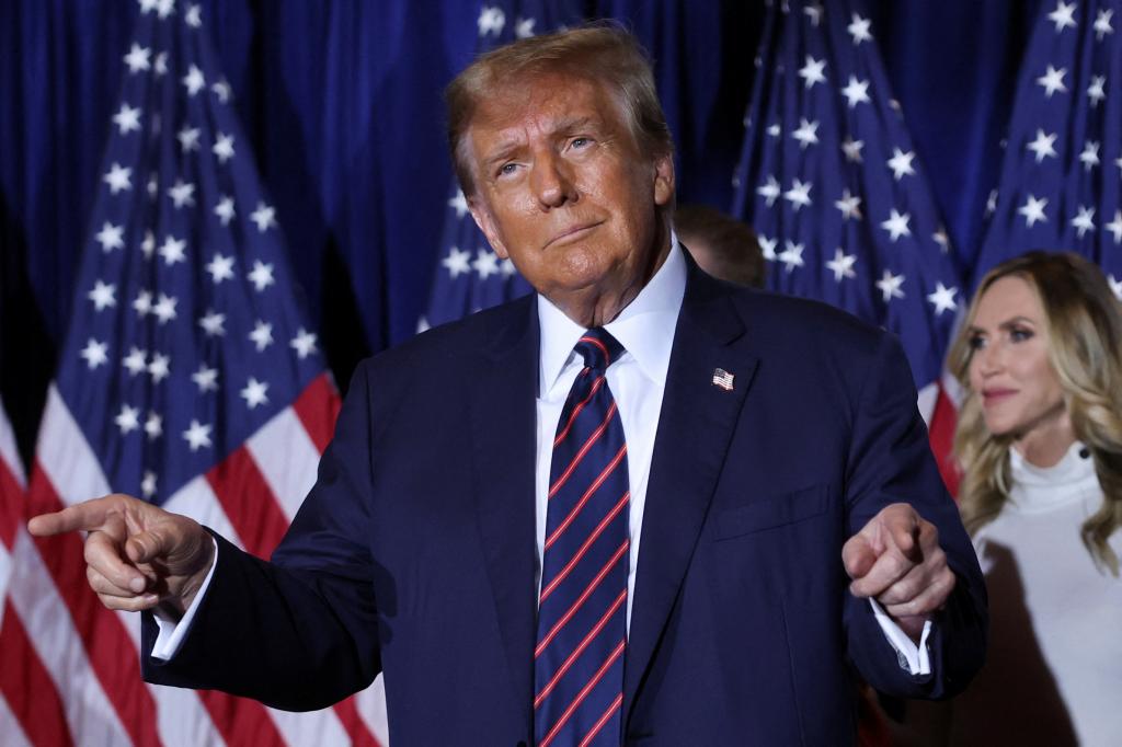 Former U.S. President Donald Trump gesturing on stage during his New Hampshire primary election night watch party, after clinching the 2024 Republican nomination.