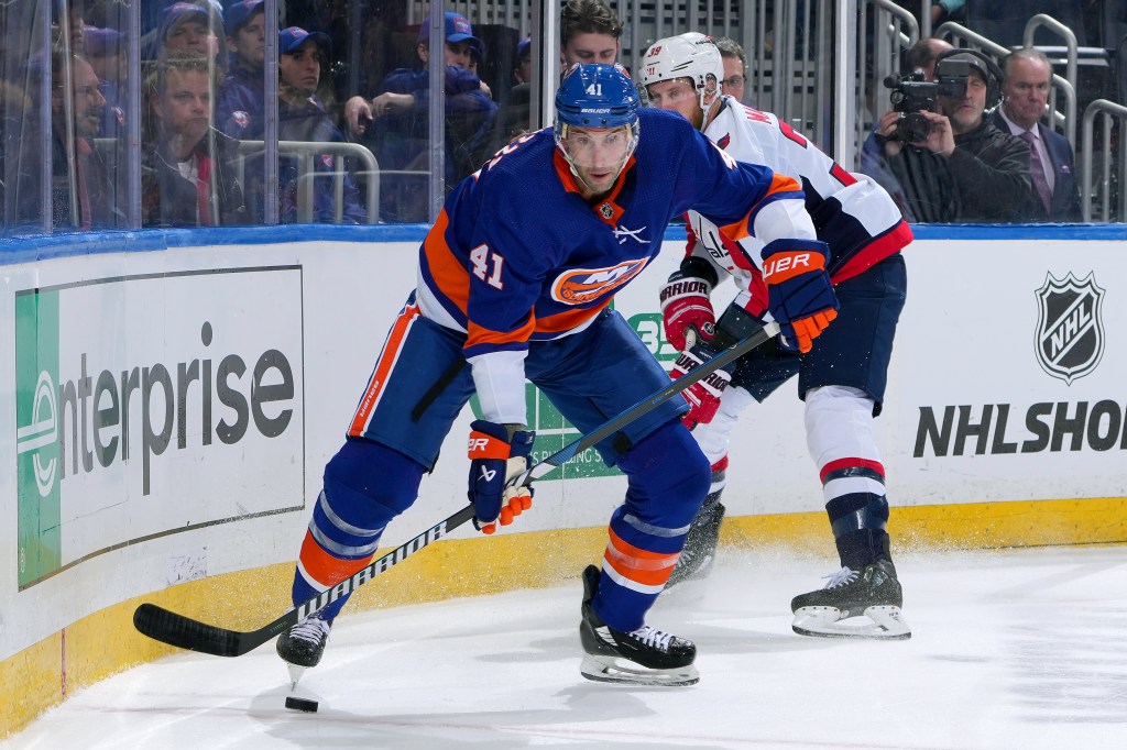 Robert Bortuzzo #41 of the New York Islanders is pursued by Anthony Mantha #39 of the Washington Capitals