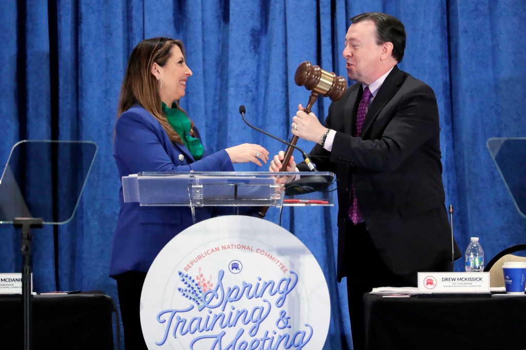 Ronna McDaniel, outgoing Republican National Committee chairwoman, left, hands over the gavel to co-chair Drew McKissick, right, after giving her last speech in the position at the general session of the RNC Spring Meeting Friday, March 8, 2024, in Houston. McDaniel is succeeded as Chairman by Michael Whatley, who won by unanimous voice vote. (AP Photo/Michael Wyke)
