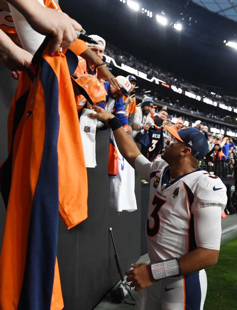 Russell Wilson #3 of the Denver Broncos interacts with fans after a loss to the Las Vegas Raiders at Allegiant Stadium on January 7, 2024 in Las Vegas, Nevada.  