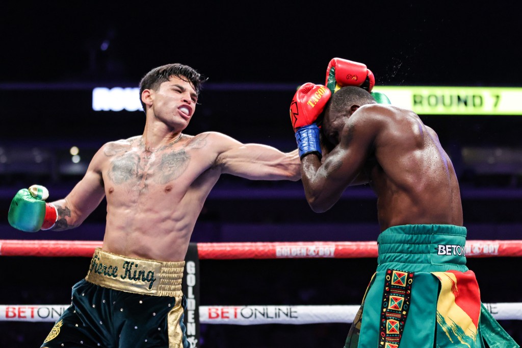 Ryan Garcia and  Emmanuel Tagoe exchange punches during their Lightweight bout at the Alamodome on April 9, 2022 in San Antonio, Texas.  