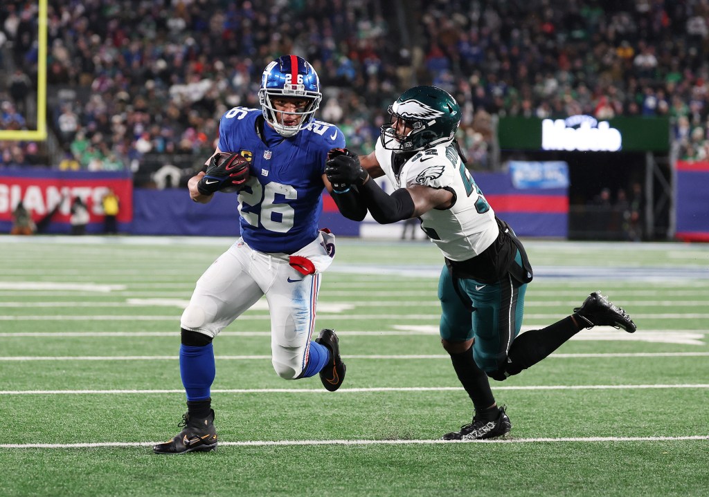 Saquon Barkley #26 of the New York Giants scores a touchdown against Zach Cunningham #52 of the Philadelphia Eagles during their game at MetLife Stadium on January 7, 2024 in East Rutherford, New Jersey.  