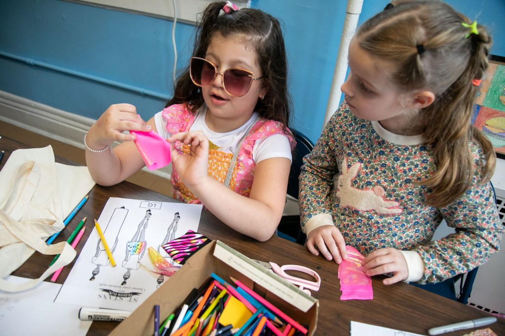 Sarina DeStefano, 7 years-old, left, and Olympia Moreau, 6 years-old, right, work on a mood board.