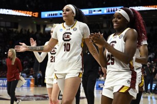 Raven Johnson #25 and Kamilla Cardoso #10 of the South Carolina Gamecocks walk off the court after their win over the North Carolina Tar Heels during the second round of the NCAA Women’s Basketball Tournament.