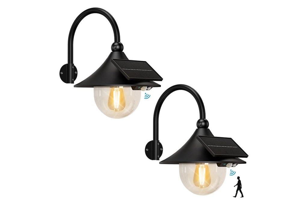 two black solar-powered sconces