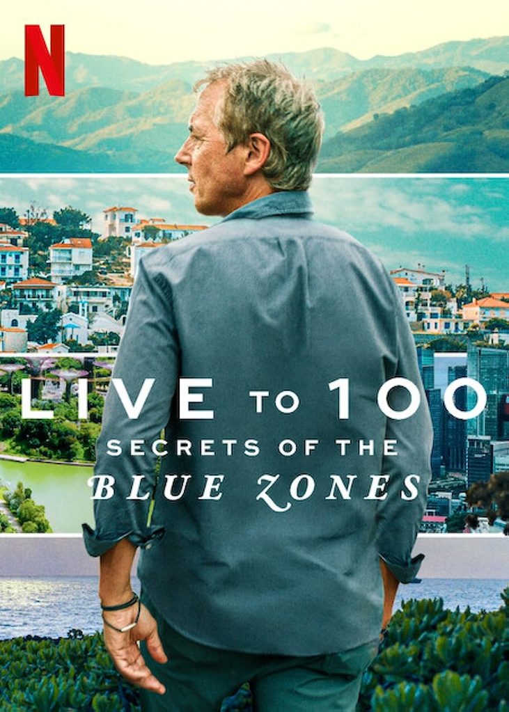 Promotional art for "Live to 100: Secrets of the Blue Zones" with Netflix logo. A man stares our over a pretty coastline in a quaint town. 