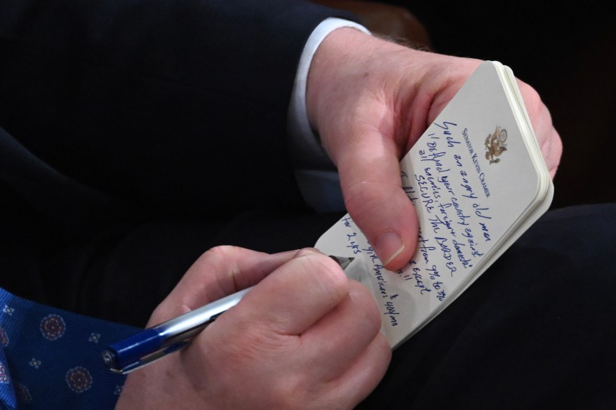 Senator Kevin Cramer takes notes as US President Joe Biden delivers the State of the Union address.
