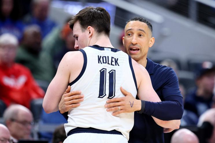 Head coach Shaka Smart of the Marquette Golden Eagles hugs Tyler Kolek #11 against the Western Kentucky Hilltoppers during the second half in the first round of the NCAA Men's Basketball Tournament.