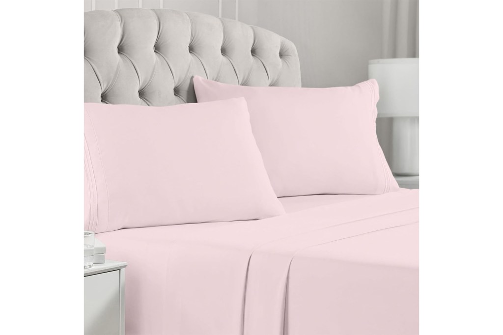 A bed with pink sheets
