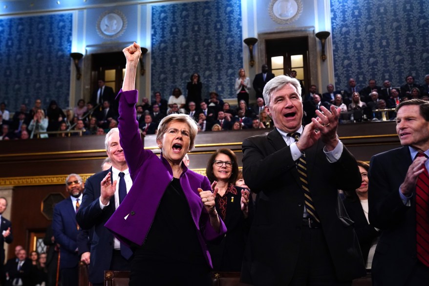 Democratic Senators Elizabeth Warren from Massachusetts (L) and Sheldon Whitehouse from Rhode Island (L) cheer.