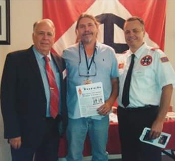 McClanahan (center) is shown with Knights of the KKK Party leaders Thomas and Jason Robb.