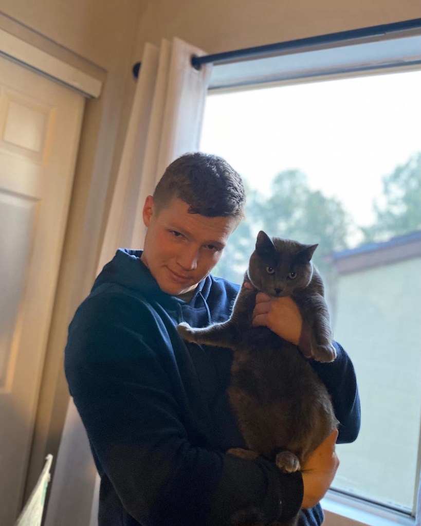 Garrison Brown holding a cat. 