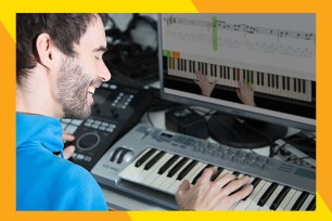 A man playing piano and smiling.