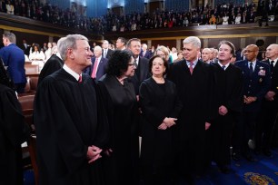Chief Justice of the Supreme Court John Roberts (L), along with Associate Justices (L-R) Sonia Sotomayor, Elena Kagan, Neil Gorsuch, and Brett Kavanaugh stand in the House of Representatives ahead of US President Joe Biden's third State of the Union address to a joint session of Congress in the US Capitol in Washington, DC.