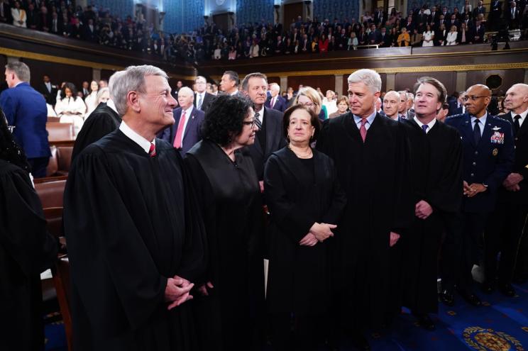 Chief Justice of the Supreme Court John Roberts (L), along with Associate Justices (L-R) Sonia Sotomayor, Elena Kagan, Neil Gorsuch, and Brett Kavanaugh stand in the House of Representatives ahead of US President Joe Biden's third State of the Union address to a joint session of Congress in the US Capitol in Washington, DC.