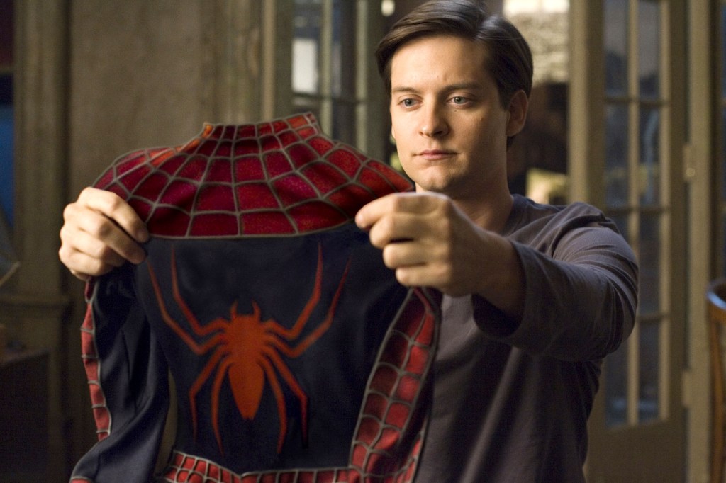 Tobey Maguire holding the Spider-Man suit