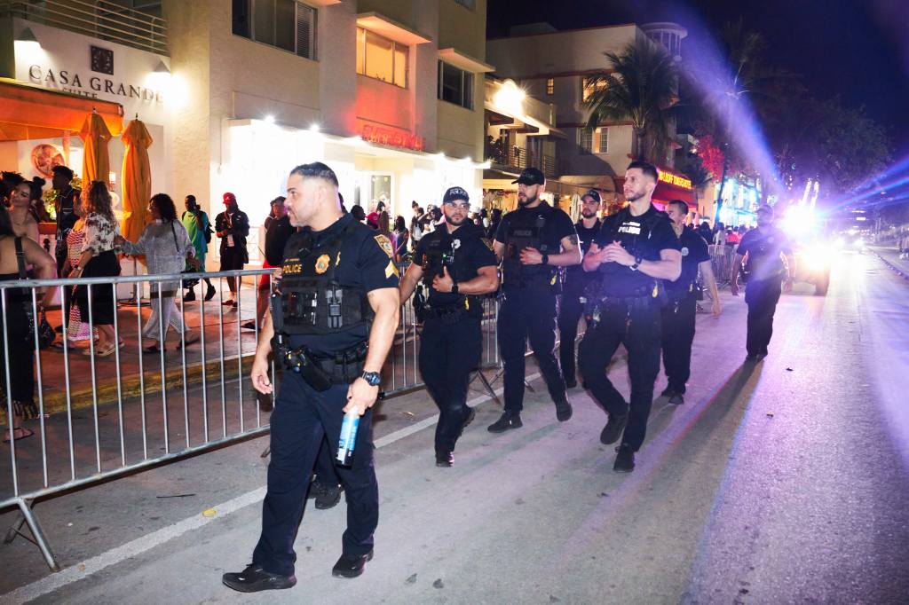 Spring Breakers party on Miami Beach with people dancing and holding drinks (Roman Maurice for NY Post).