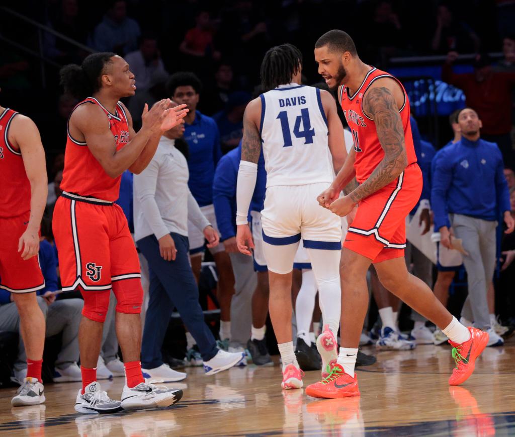 Red Storm center Joel Soriano #11, and St. John's Red Storm guard Jordan Dingle #3, react