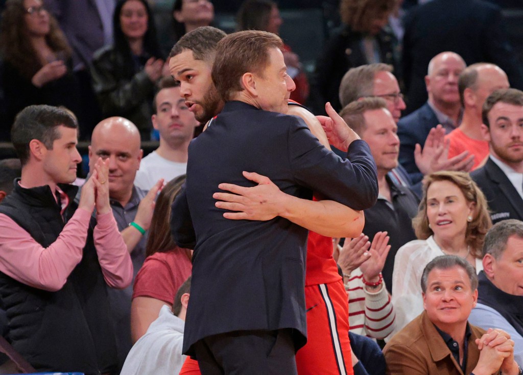 St. John's Red Storm Head Coach Rick Pitino hugging St. John's Red Storm guard Chris Ledlum #8, in the closing minutes of the 2nd half.