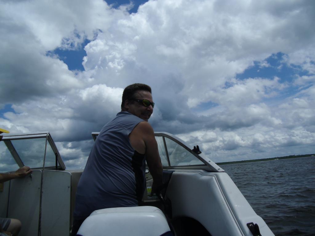 John Barnett driving a motor boat on the water