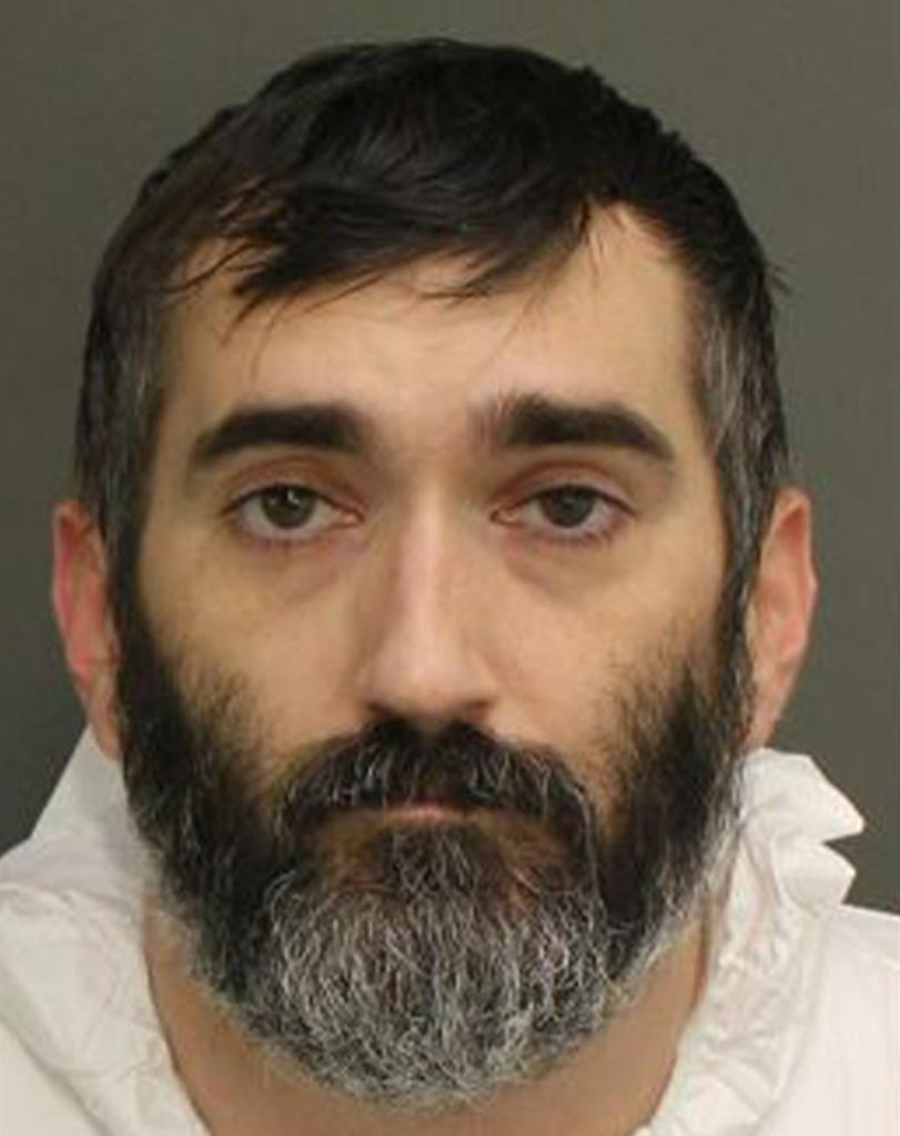 A mug shot of Stephan Sterns, a white man with dark hair and a beard flecked with gray.