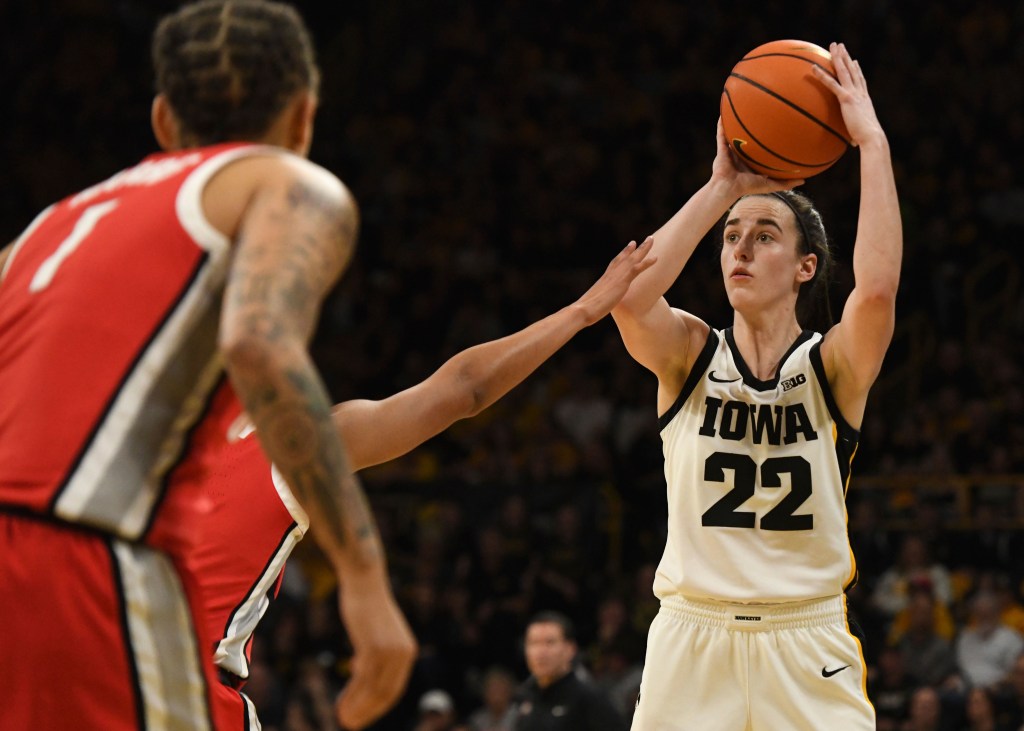 Iowa guard Caitlin Clark (22) takes a 3-point shot over Ohio State defenders during the second half of an NCAA college basketball game, Sunday, March 3, 2024, in Iowa City, Iowa.  