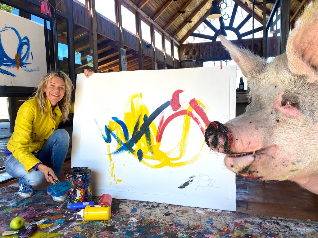 Joanne Lefson, 52, from Franschhoek, South Africa, and Pigcasso painting at Farm Sanctuary SA. 