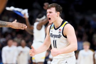 Tyler Kolek #11 of the Marquette Golden Eagles celebrates after defeating the Colorado Buffaloes in the second round of the NCAA Men's Basketball Tournament.