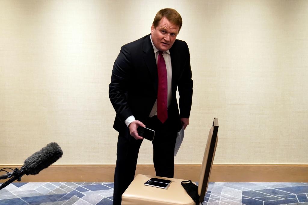 Tony Bobulinski, who says he is a former associate of Hunter Biden, holds one of three phones he displayed as he talks with reporters before the presidential debate, Thursday, Oct. 22, 2020, in Nashville. (AP Photo/Evan Vucci)