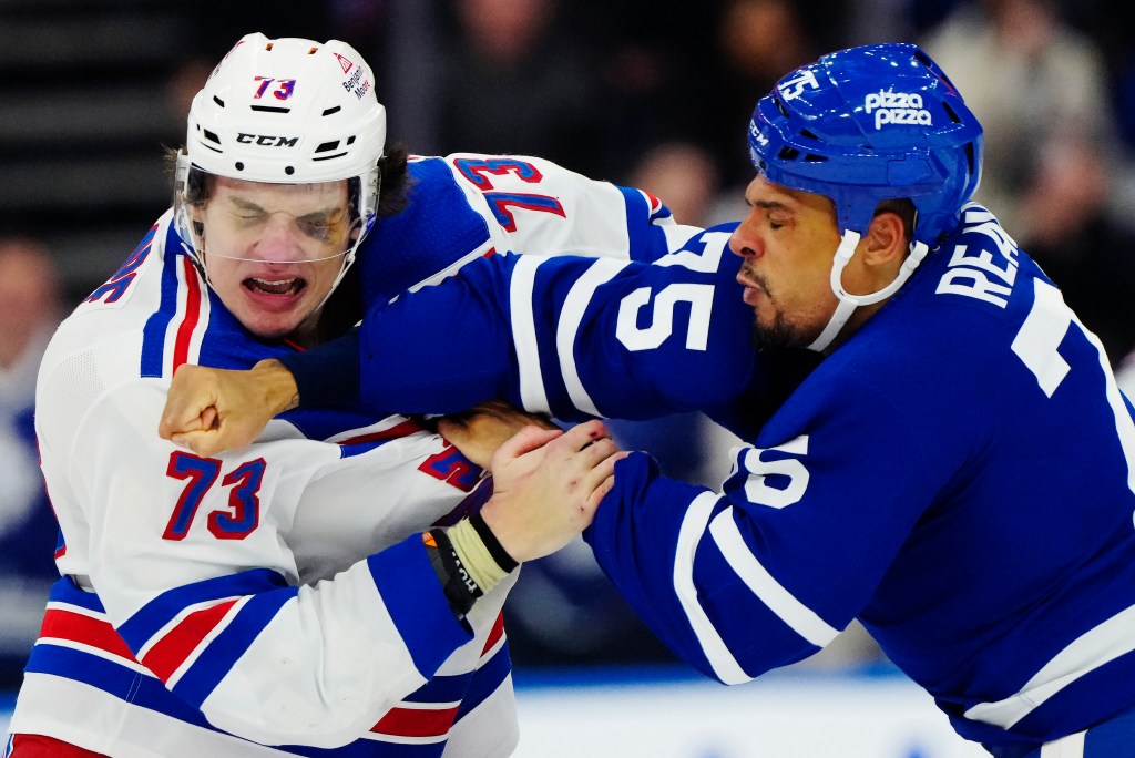 Rangers rookie Matt Rampe (l.) and the Maple Leafs' Ryan Reaves (r.) exchange punches on March 2, 2024.