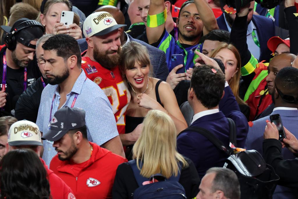 ravis Kelce #87 of the Kansas City Chiefs celebrates with Taylor Swift after defeating the San Francisco 49ers 25-22 in overtime during Super Bowl LVIII