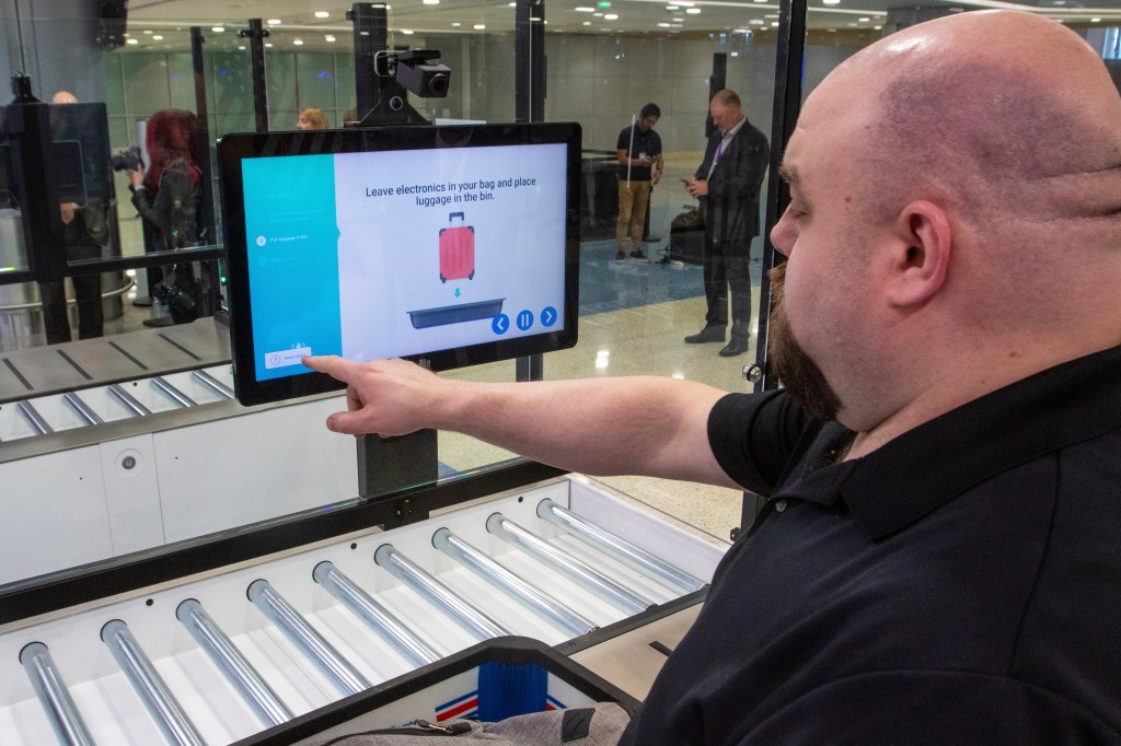 Image of TSA official demonstrating new airport screening equipment at Harry Reid International Airport, Las Vegas - March 6, 2024.