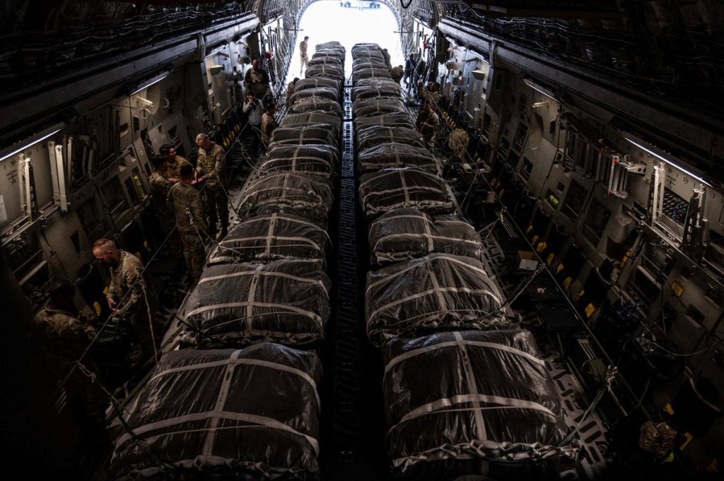 A U.S. military aircraft loaded with humanitarian aid airdrops for Gaza shows with two rows of the bundles stretching the length of the plane.