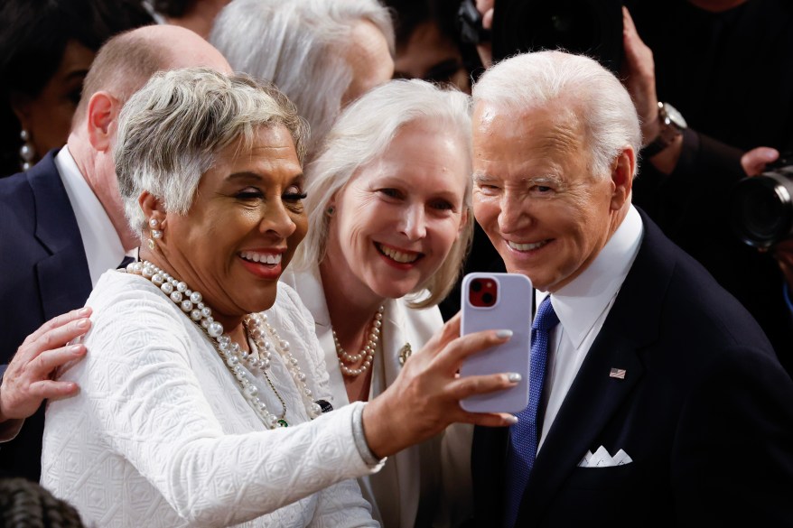 President Joe Biden poses for a photo after delivering the annual State of the Union speech.