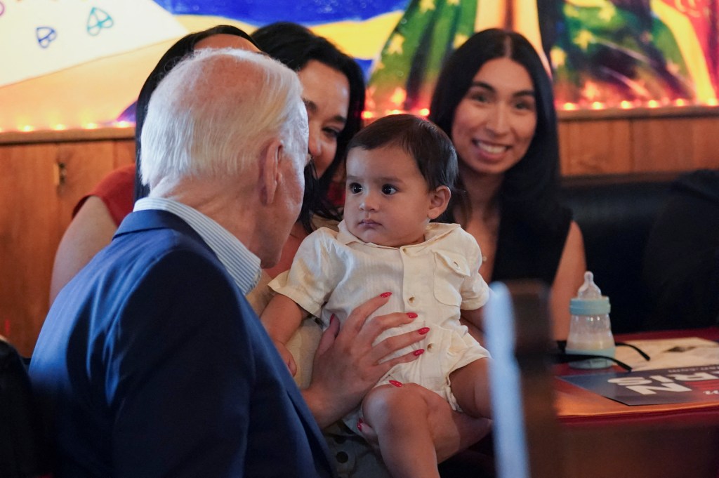 President Joe Biden greets a baby during a campaign event at a Mexican restaurant in the Phoenix area, Arizona, U.S., March 19, 2024