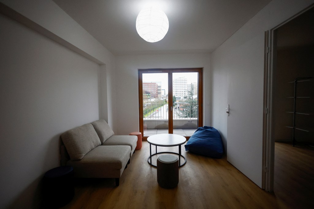 A flat with a couch and a table prepared for athletes in the Olympic and Paralympic Village ahead of Paris 2024.