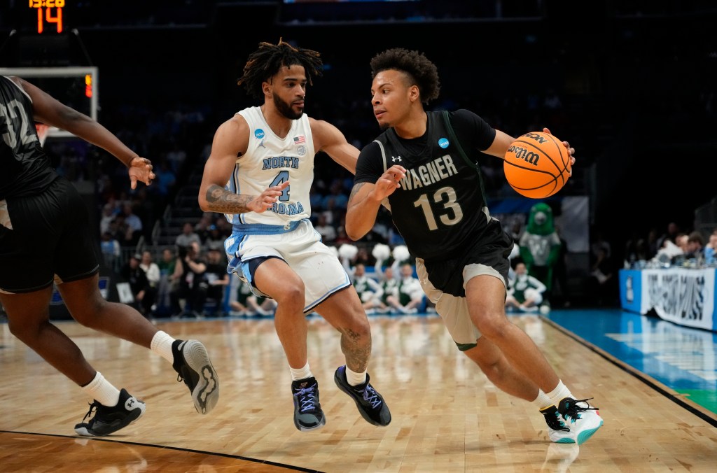 Wagner Seahawks guard Julian Brown (13) drives past North Carolina Tar Heels guard RJ Davis