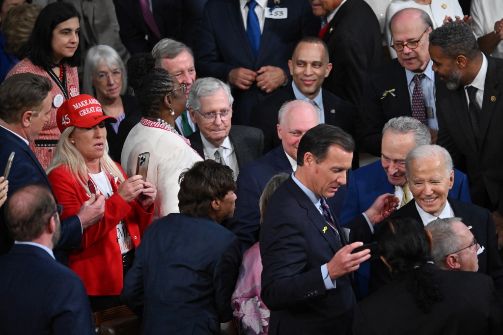 Marjorie Taylor-Greene (R-GA) wears a MAGA hat as US President Joe Biden arrives to deliver the State of the Union address.