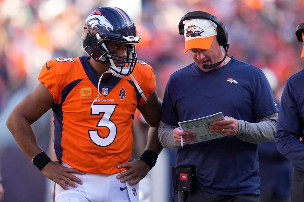 Denver Broncos quarterback Russell Wilson (3) talks with head coach Nathaniel Hackett during the second half of an NFL football game against the Houston Texans, Sunday, Sept. 18, 2022, in Denver. 